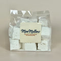 White marshmallows in clear packaging with a "MooMallow" label on the font against a neutral background