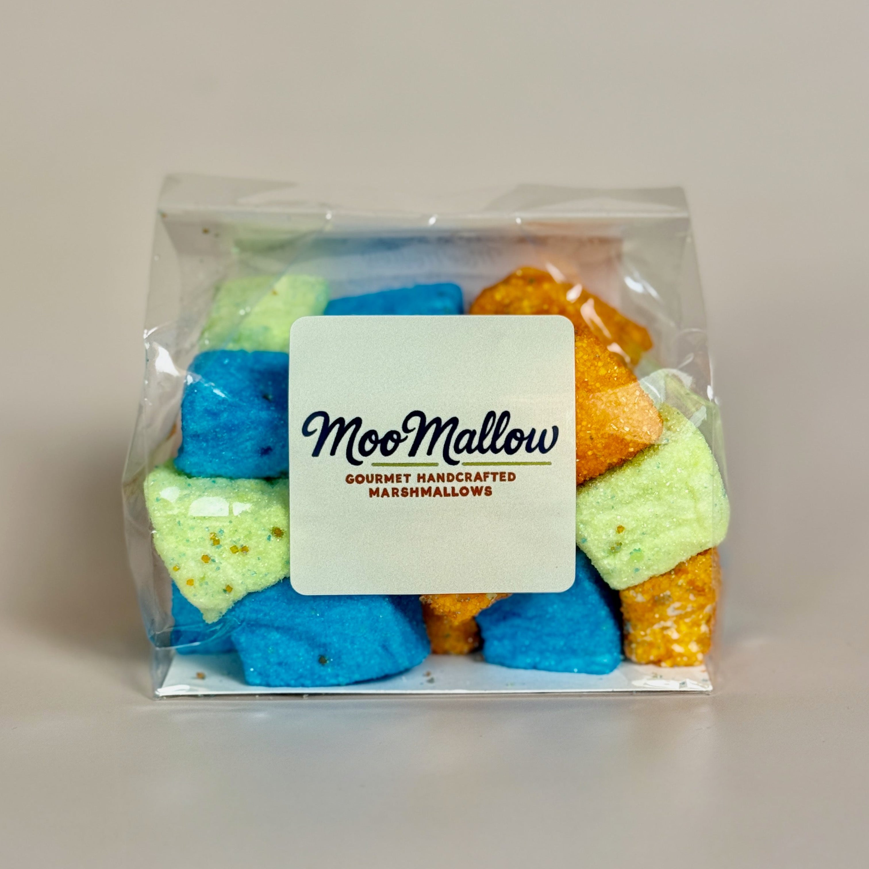 Packaged colorful marshmallows with a 'MooMallow' label on a plain background