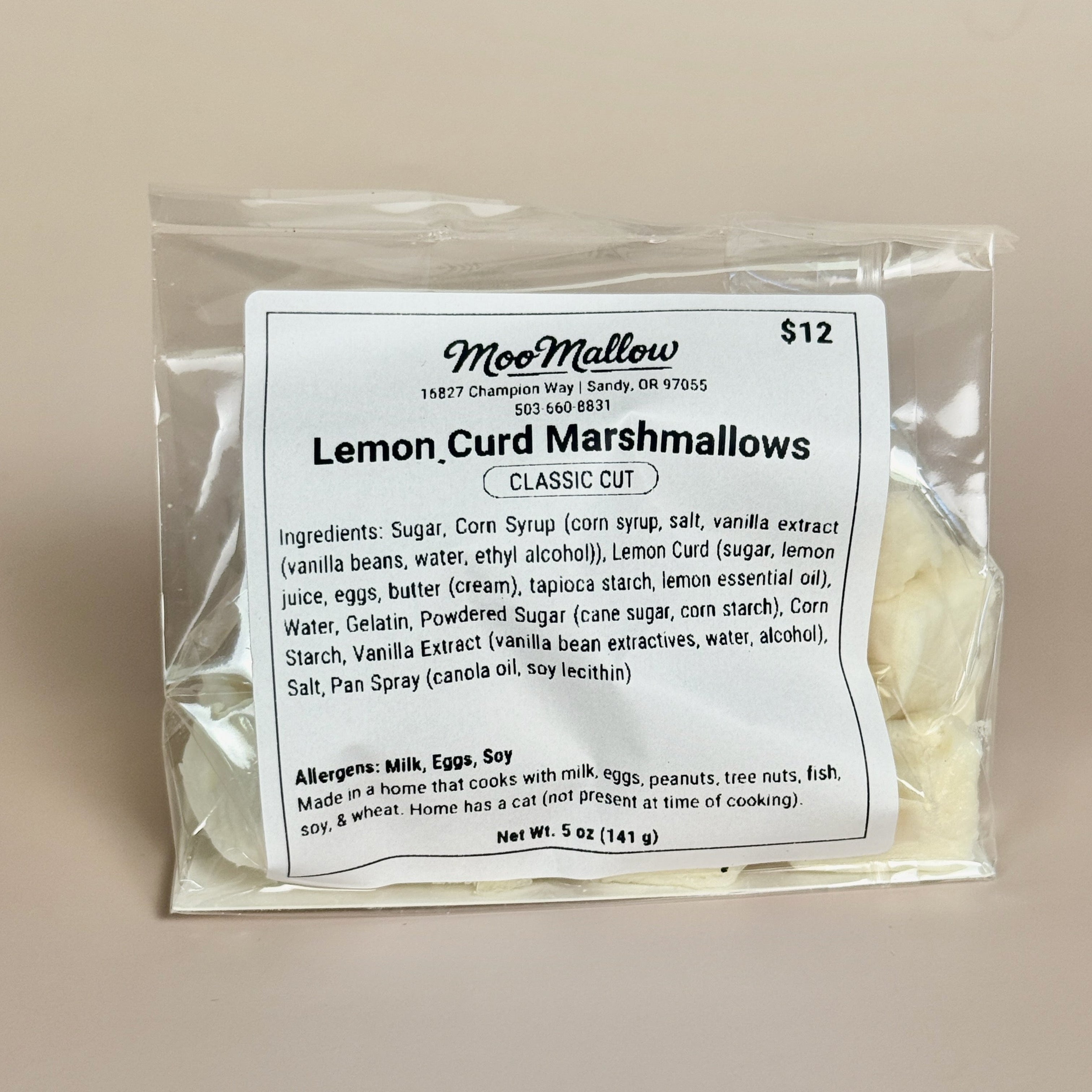 Packaged lemon curd marshmallows with a label on a beige background
