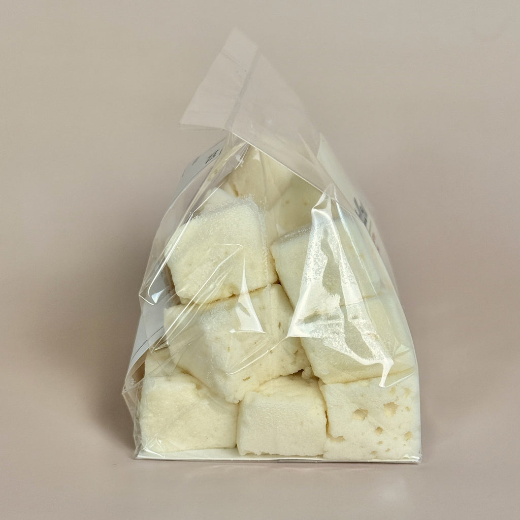 Clear plastic bag with white cubes on a beige background