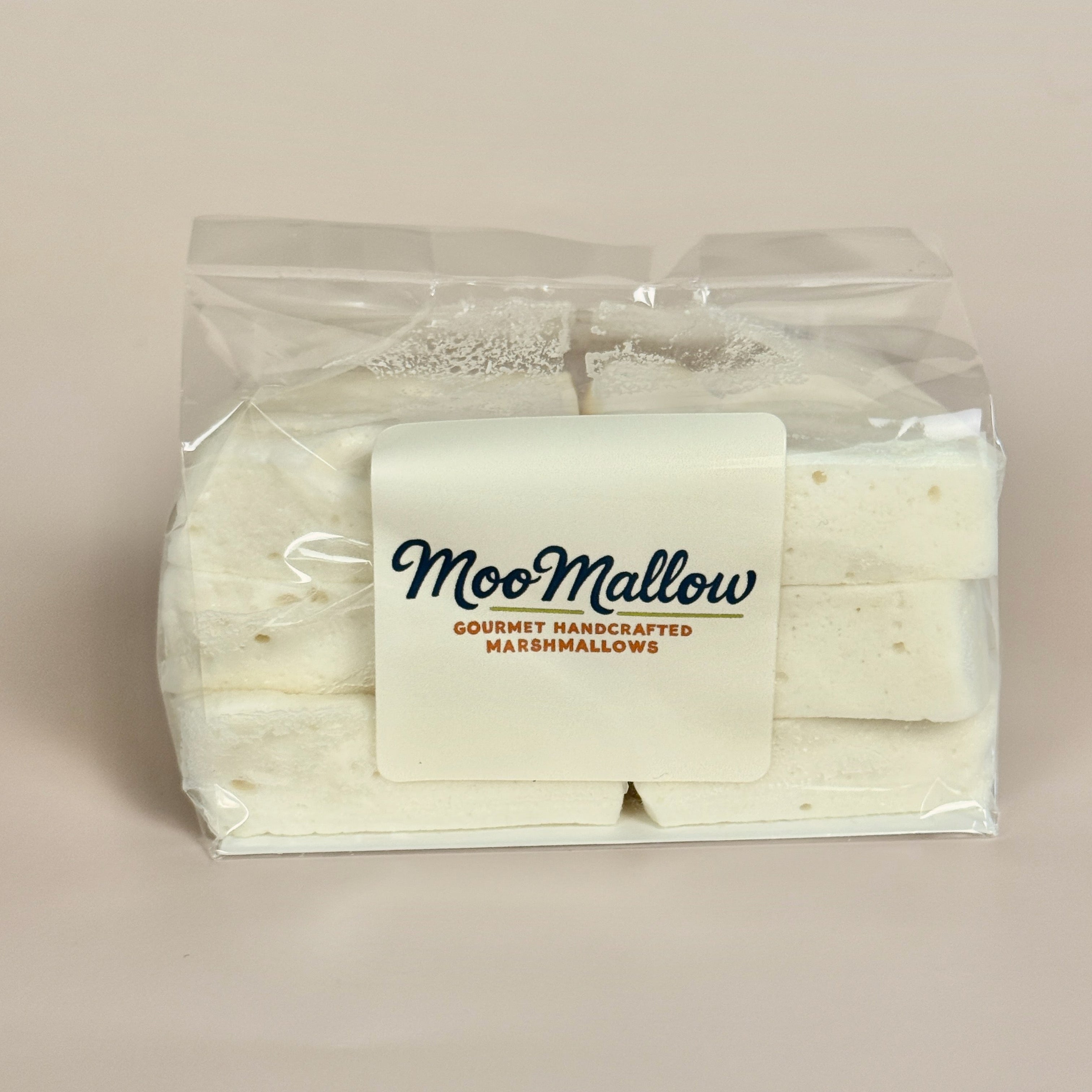Packaged marshmallows with 'MooMallow' branding on a beige background