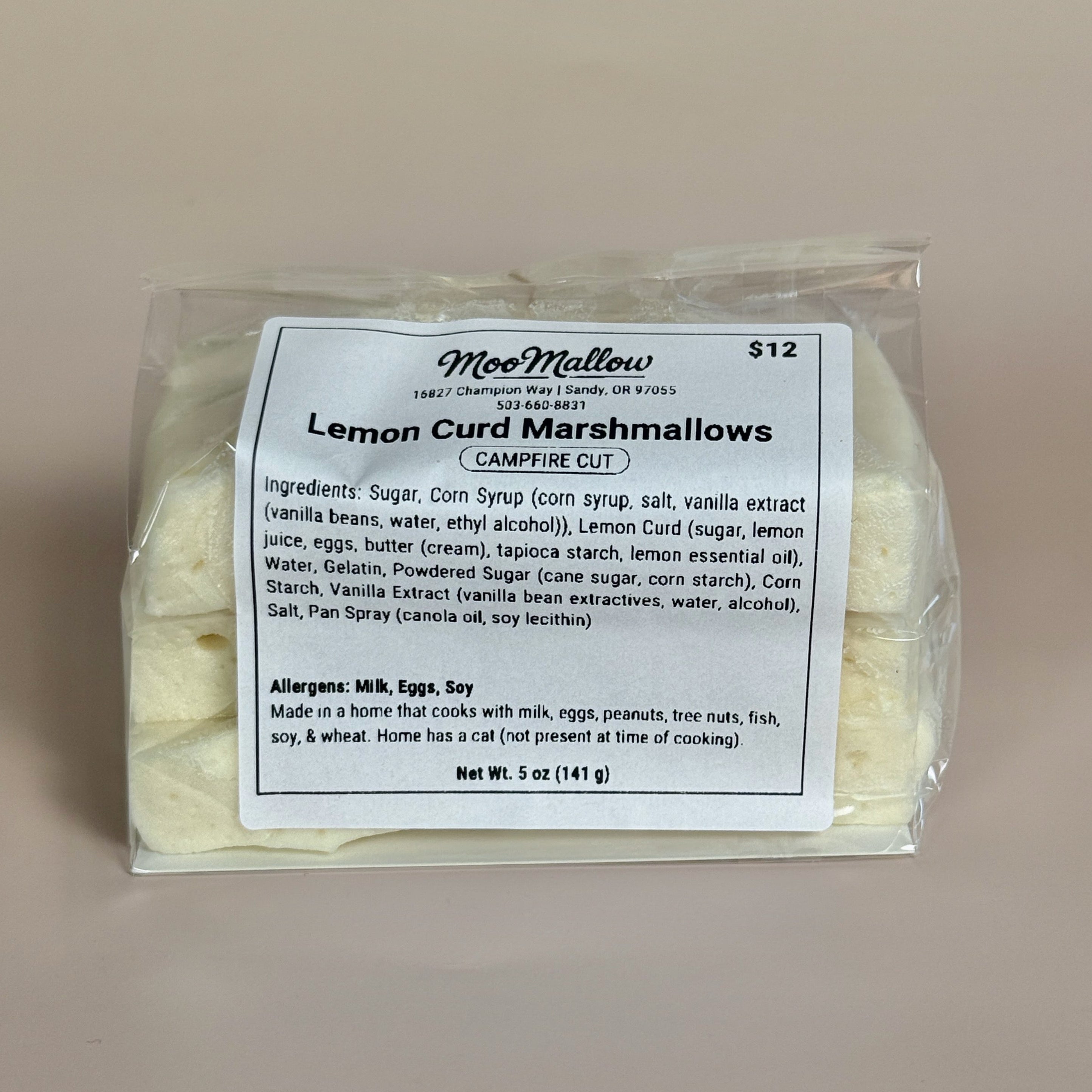 Packaged lemon curd marshmallows with a label on a beige background